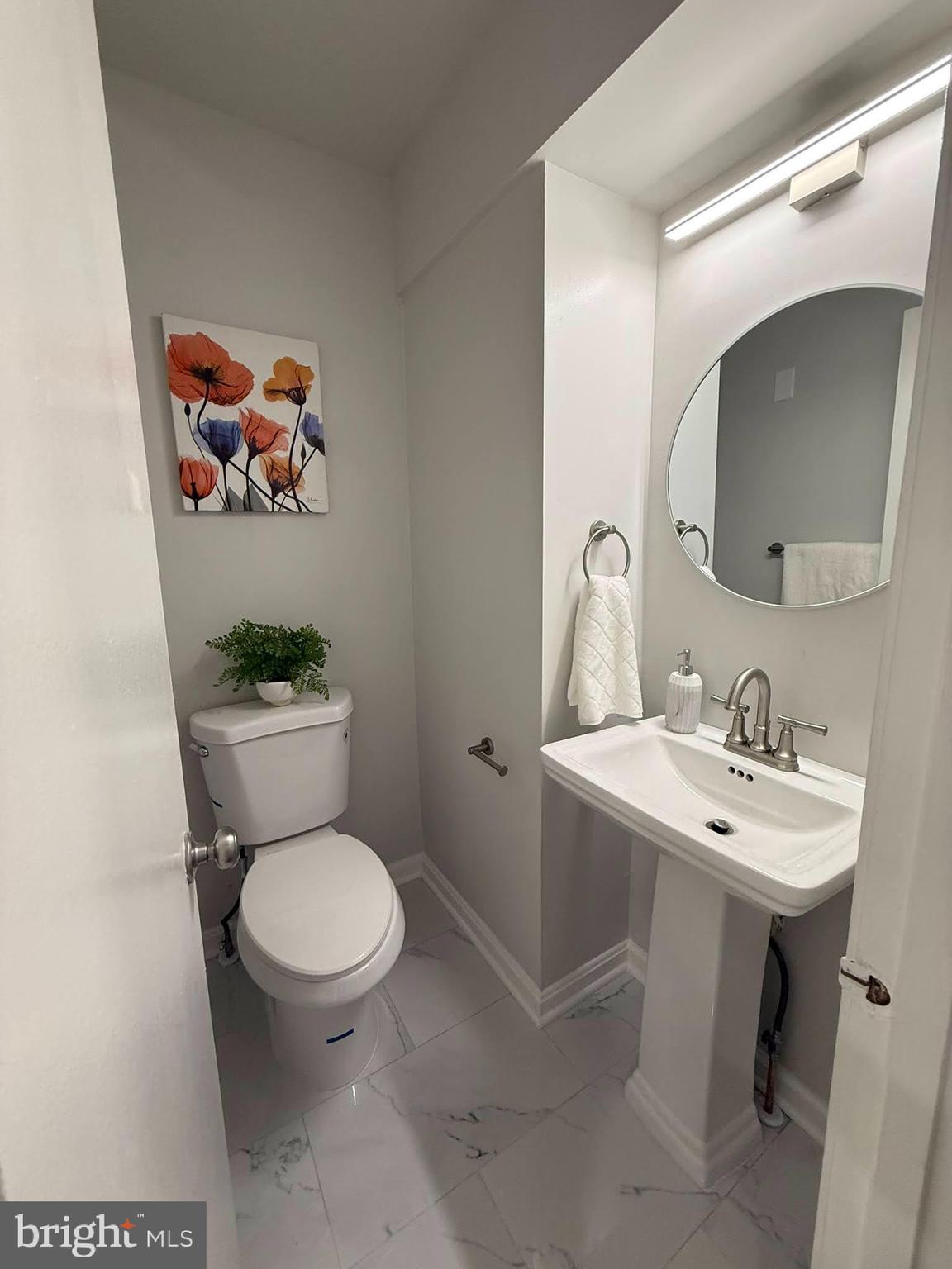 8580 Tyrolean Way Springfield, VA 22153 - Photo 15 of 63 a bathroom with a toilet sink and mirror