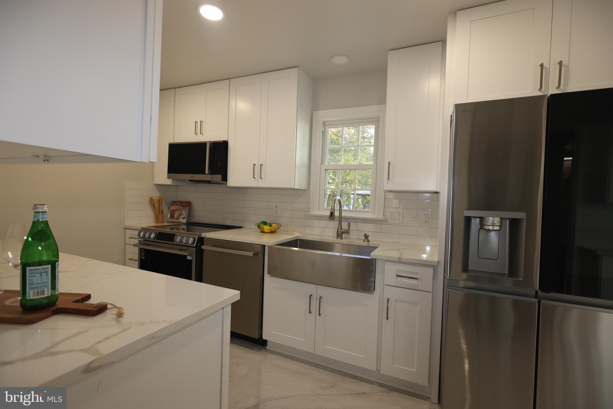8580 Tyrolean Way Springfield, VA 22153 - Photo 17 of 63 a kitchen with a sink appliances and cabinets