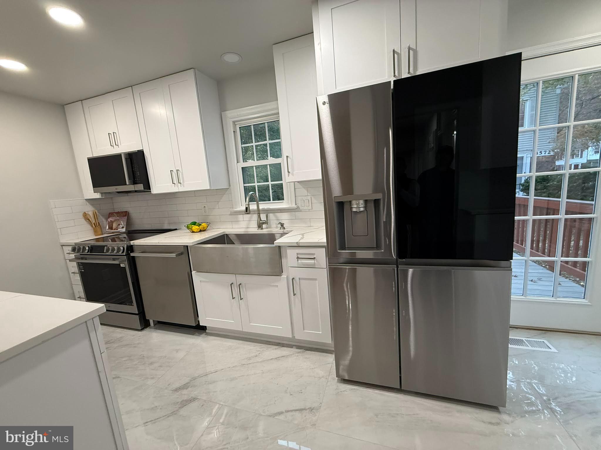 8580 Tyrolean Way Springfield, VA 22153 - Photo 18 of 63 a kitchen with a refrigerator stove and sink