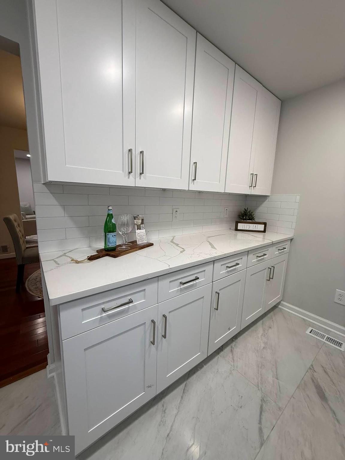 8580 Tyrolean Way Springfield, VA 22153 - Photo 20 of 63 a kitchen with white cabinets and white appliances