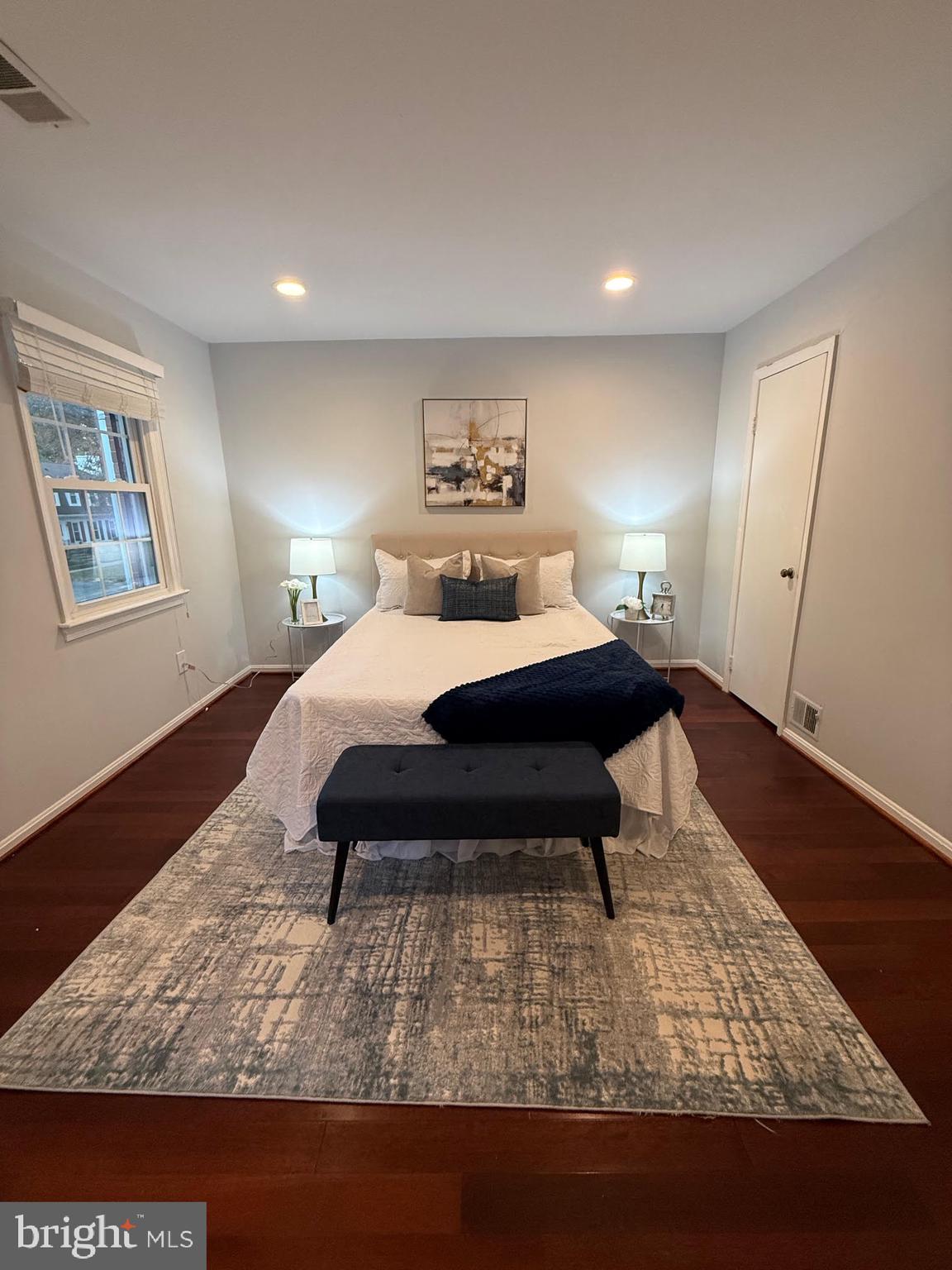 8580 Tyrolean Way Springfield, VA 22153 - Photo 25 of 63 a bedroom with a bed and wooden floor