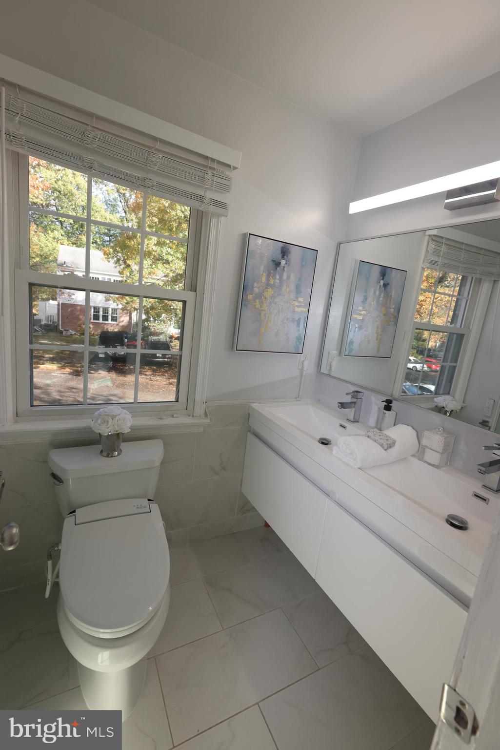 8580 Tyrolean Way Springfield, VA 22153 - Photo 28 of 63 a bathroom with a toilet sink and mirror