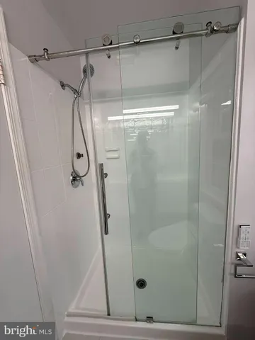 a bathroom with a granite countertop sink a toilet and shower