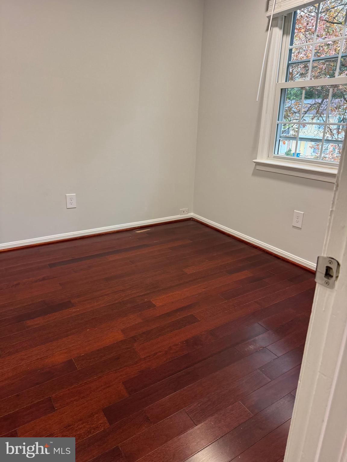 8580 Tyrolean Way Springfield, VA 22153 - Photo 35 of 63 an empty room with wooden floor and windows