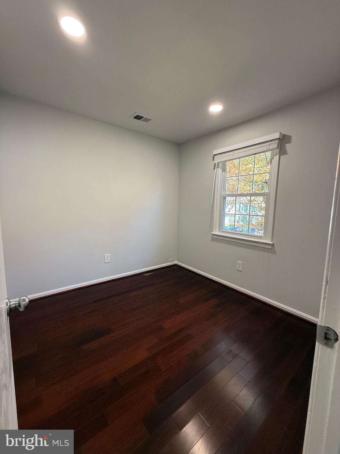 8580 Tyrolean Way Springfield, VA 22153 - Photo 36 of 63 an empty room with wooden floor and windows