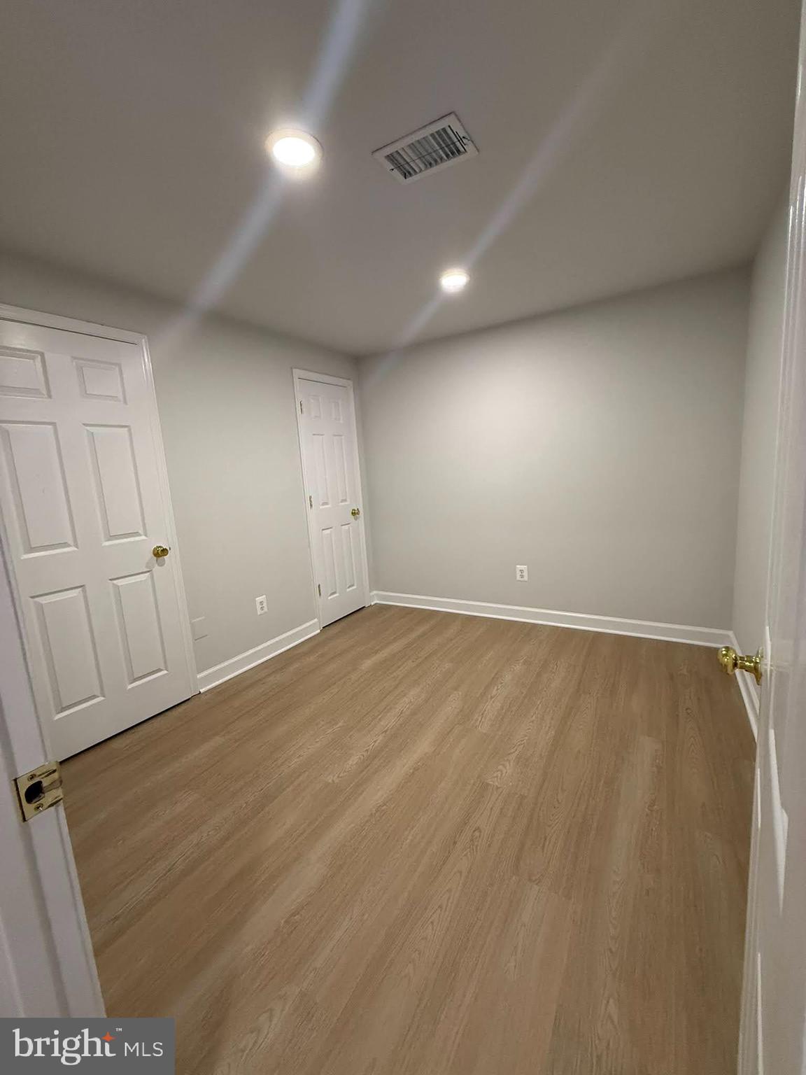 8580 Tyrolean Way Springfield, VA 22153 - Photo 39 of 63 an empty room with wooden floor and windows
