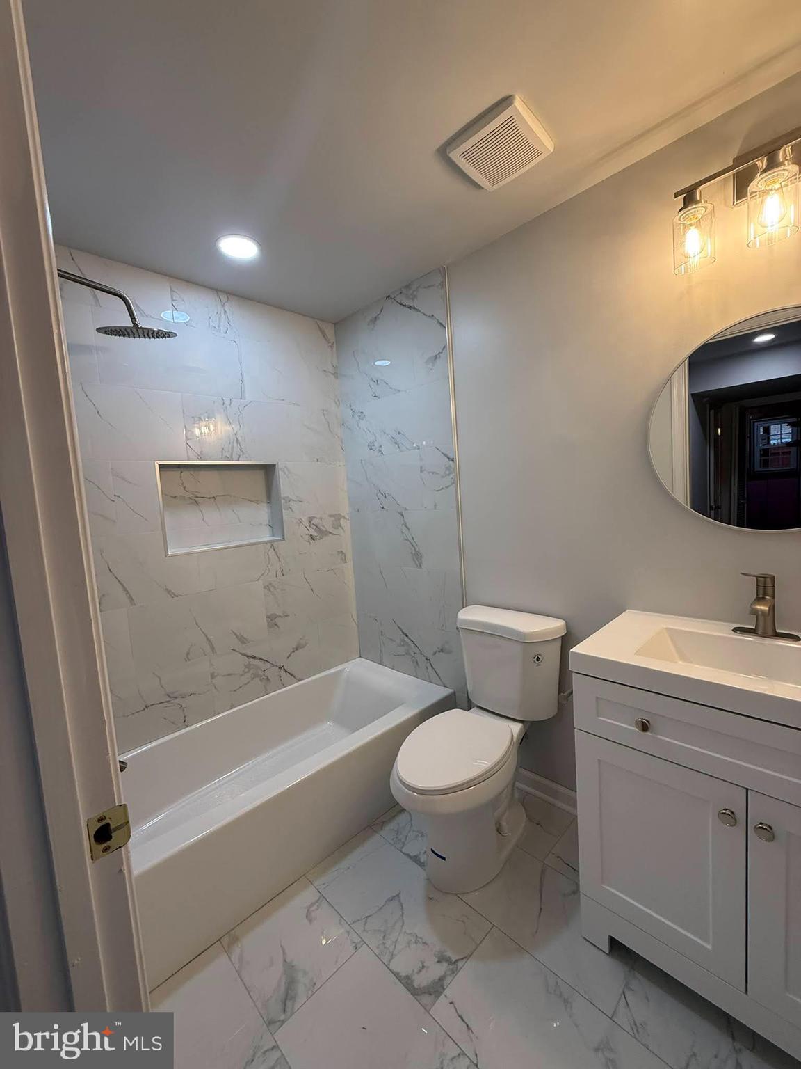 8580 Tyrolean Way Springfield, VA 22153 - Photo 41 of 63 a bathroom with a granite countertop sink a toilet and shower