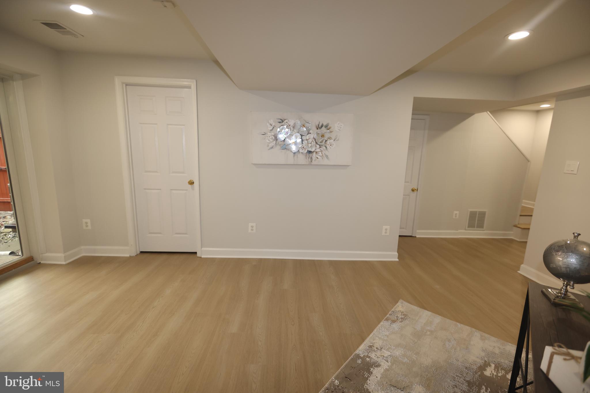 8580 Tyrolean Way Springfield, VA 22153 - Photo 44 of 63 an empty room with wooden floor and windows