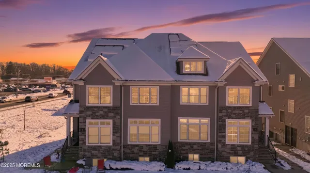 a view of a white building among the street with palm trees