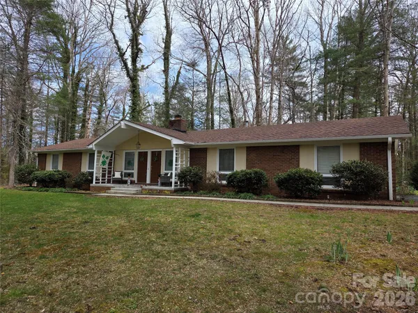 a front view of a house with yard porch and furniture