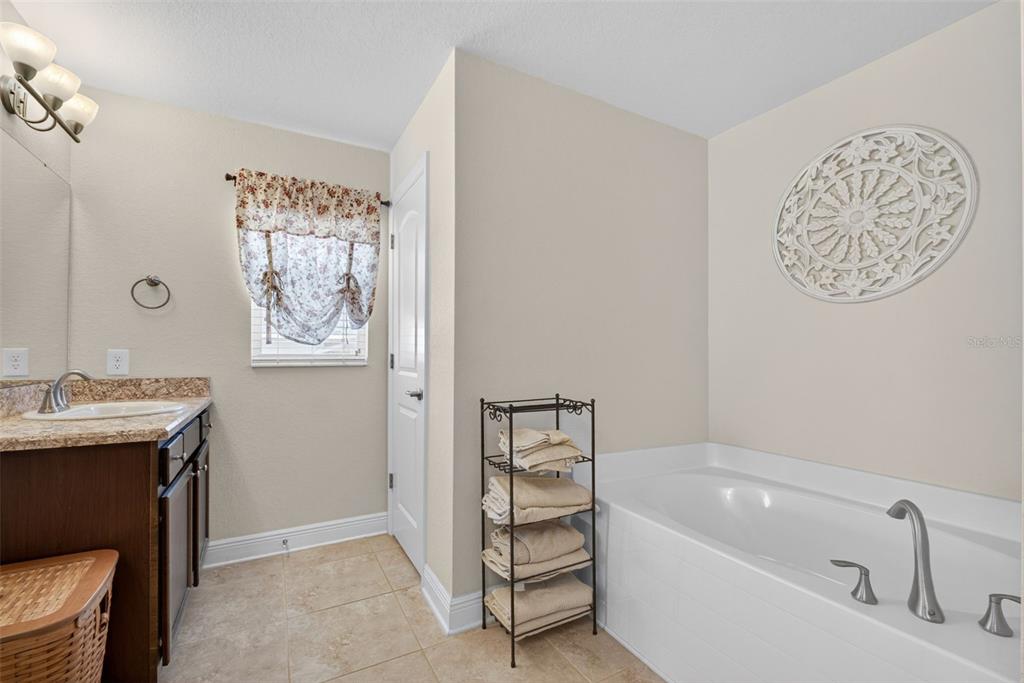 2429 Twin Lake View Road Winter Haven, FL 33881 - Photo 24 of 37 a bathroom with a tub sink and mirror