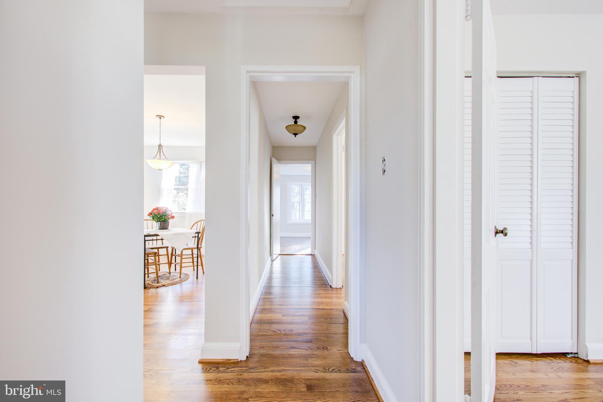 1004 Stirling Road Silver Spring, MD 20901 - Photo 14 of 27 a view of a hallway with wooden floor