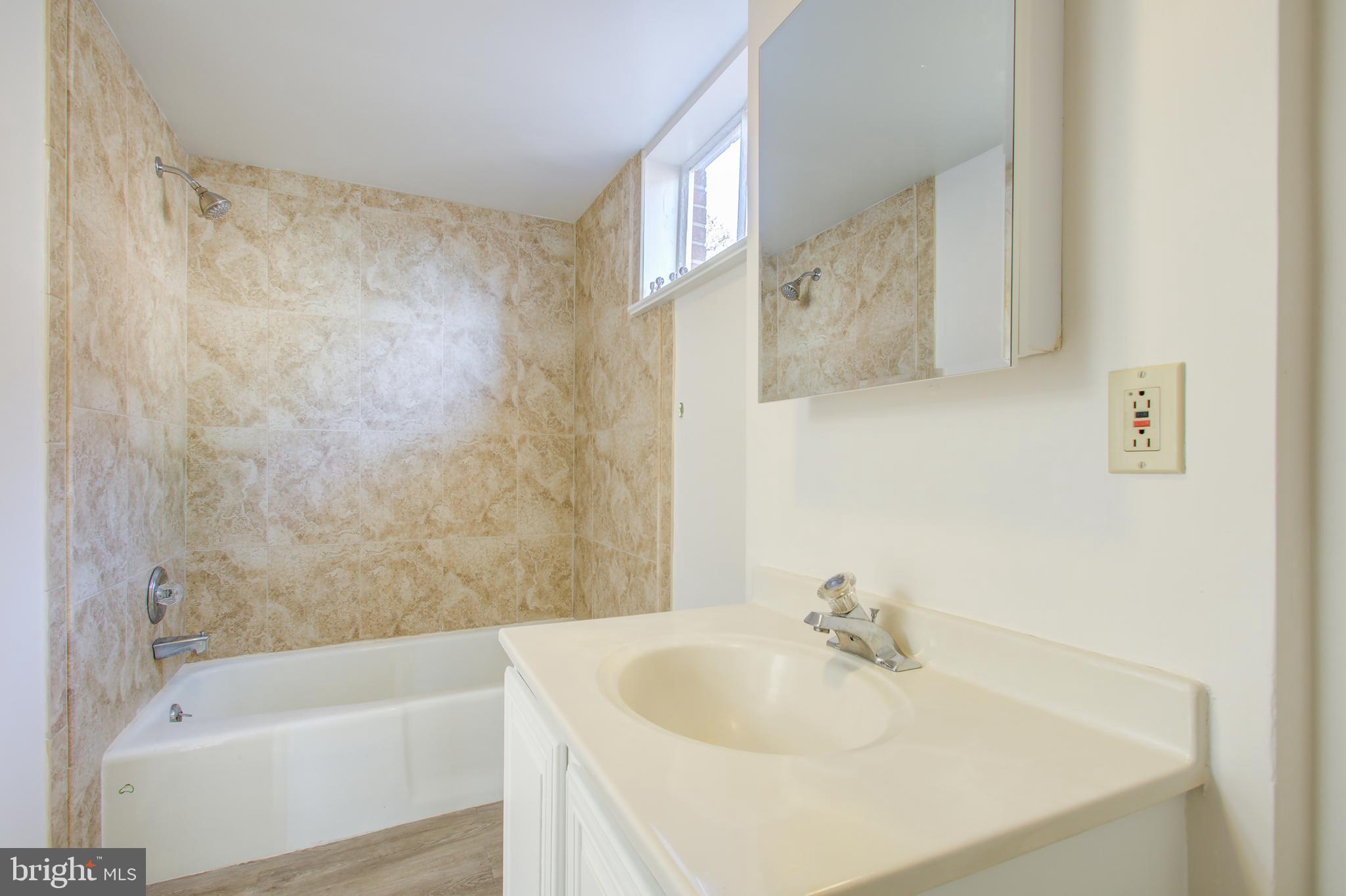 1004 Stirling Road Silver Spring, MD 20901 - Photo 20 of 27 a bathroom with a sink and a bathtub