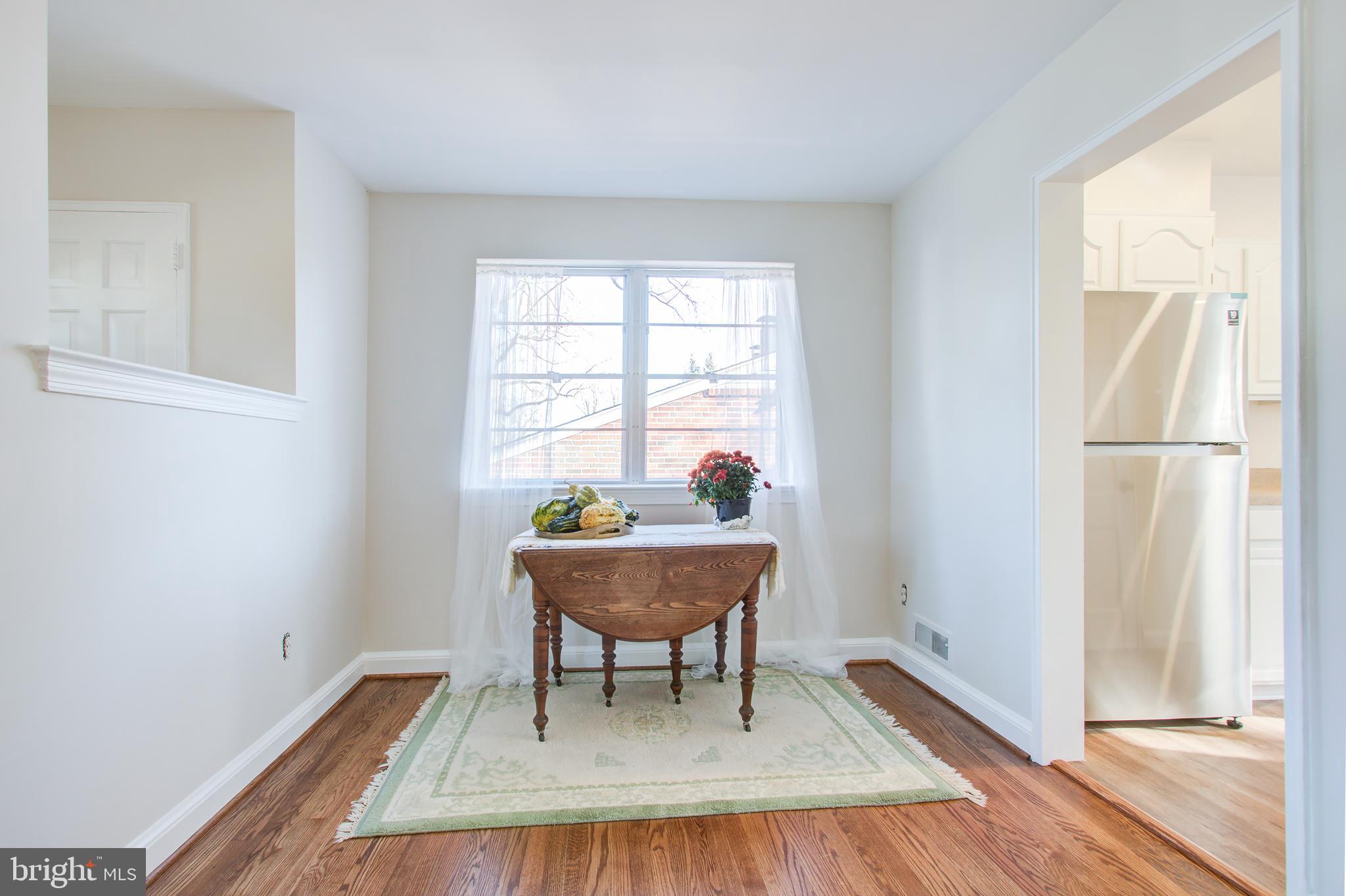 1004 Stirling Road Silver Spring, MD 20901 - Photo 5 of 27 a living room with a table and a window