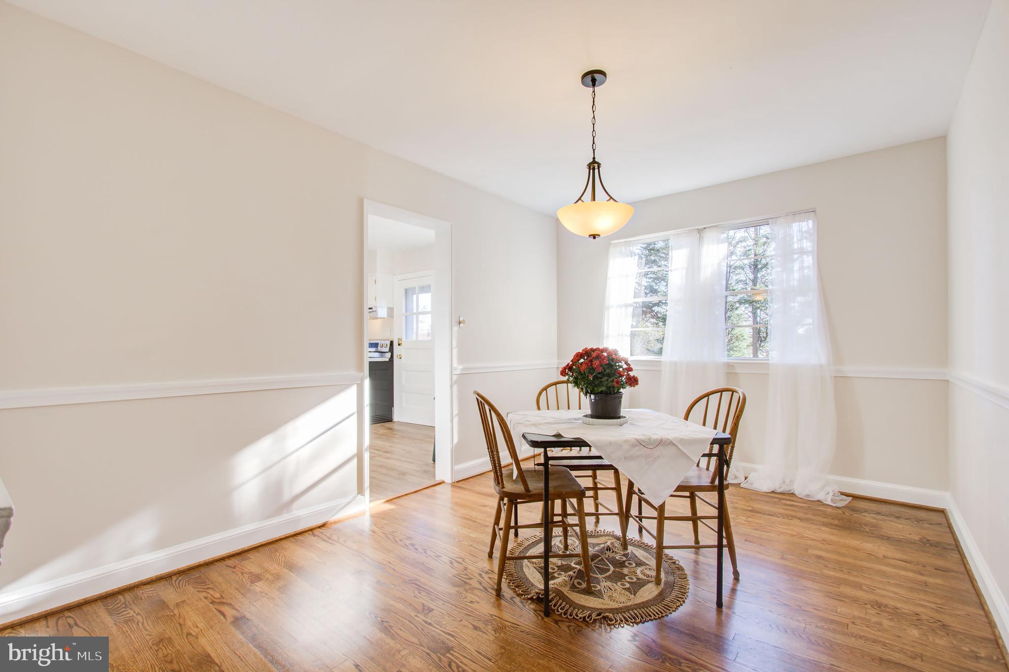 1004 Stirling Road Silver Spring, MD 20901 - Photo 7 of 27 a view of a dining room with furniture window and wooden floor