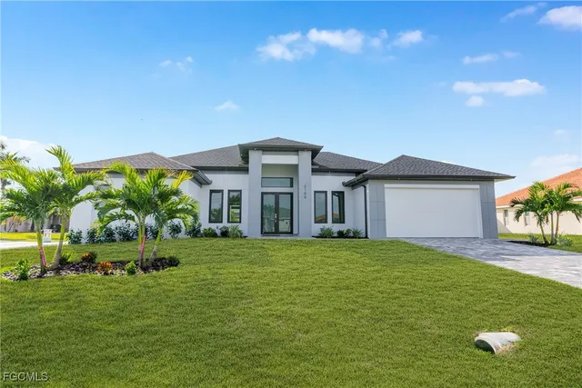 a view of a house with a big yard and potted plants