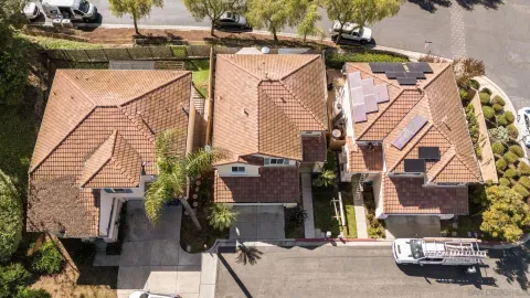 an aerial view of a house with a street
