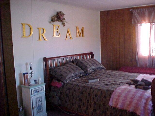 14631 Fisk Road Yakima, WA 98908 - Photo 14 of 18 a bed sitting in a bedroom next to a window