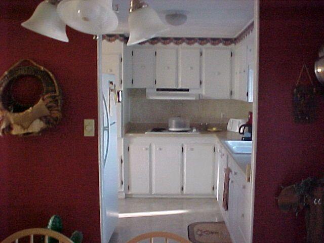 14631 Fisk Road Yakima, WA 98908 - Photo 17 of 18 a kitchen with a refrigerator and cabinets