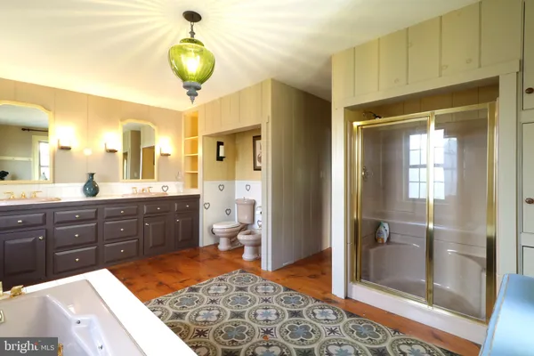 a spacious bathroom with a granite countertop sink and a large mirror