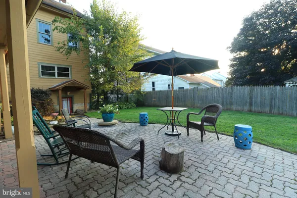 a front view of a house with garden and patio