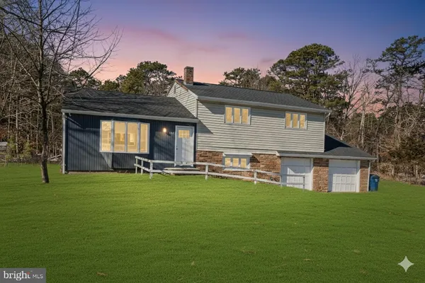 a front view of house with yard and seating area
