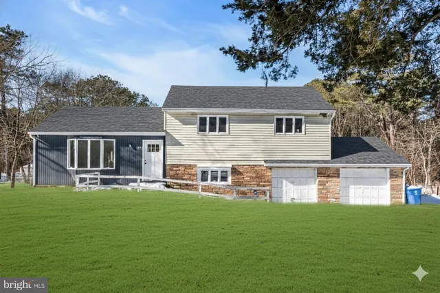 a front view of house with yard and outdoor seating