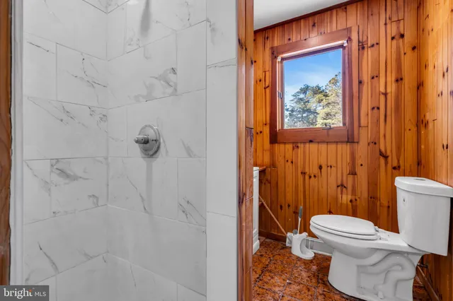 a white toilet sitting next to a bathroom sink