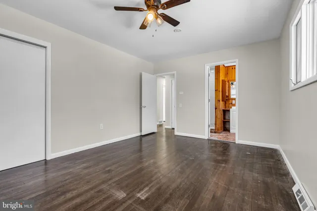 wooden floor in an empty room with a window
