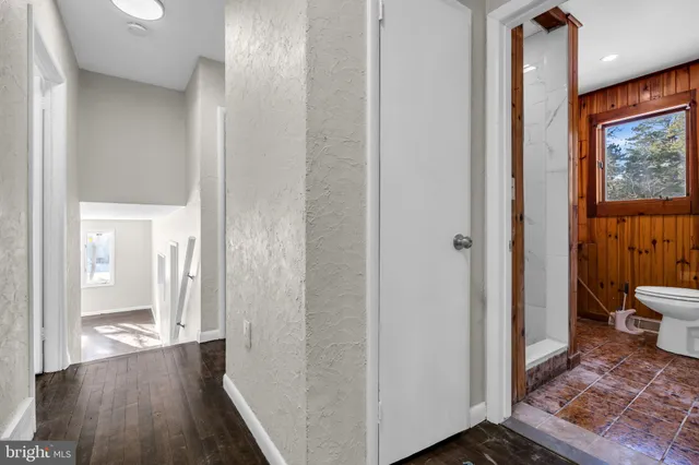 a view of a bathroom from a hallway