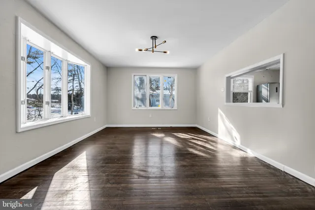 a view of a room with a bed and a ceiling fan