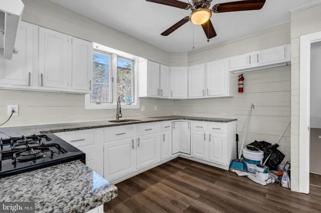 a kitchen with stainless steel appliances a stove a sink and a refrigerator