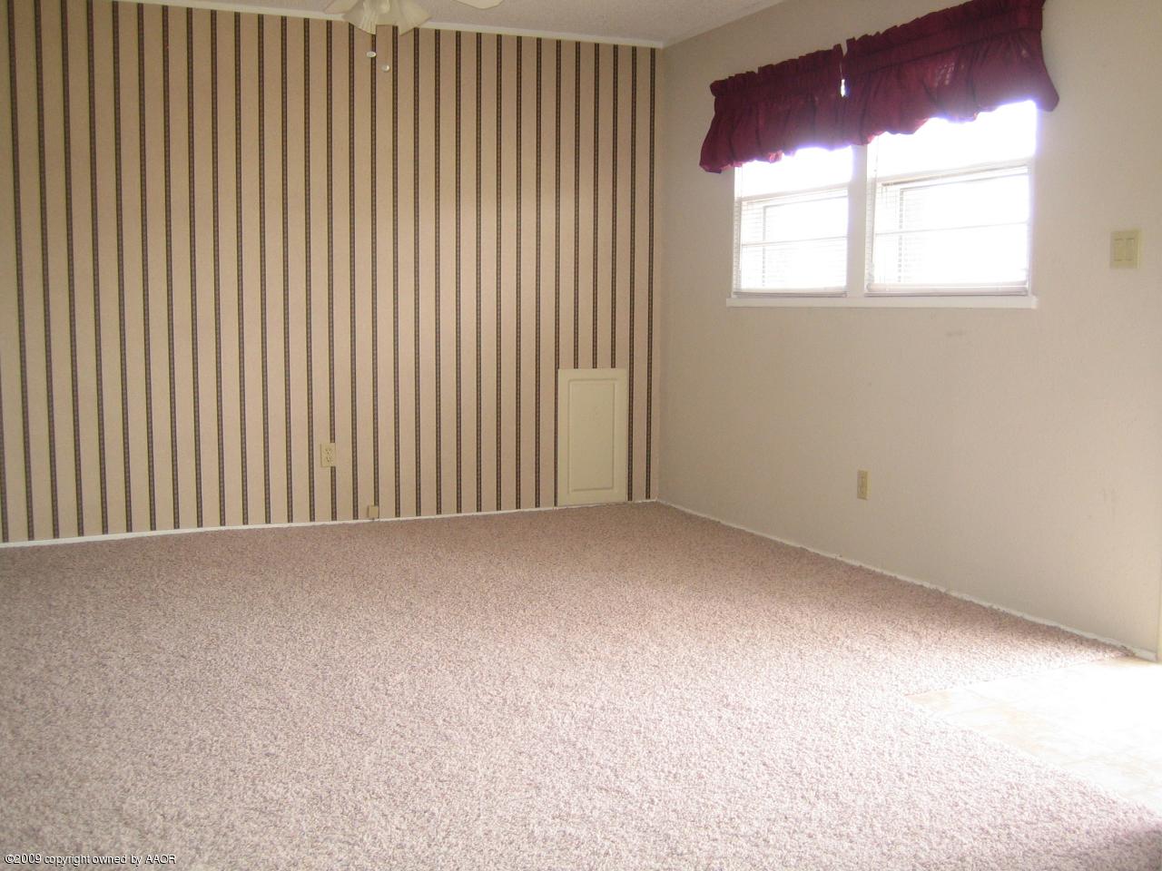 5019 Bowie Street Amarillo, TX 79110 - Photo 3 of 10 an empty room with windows