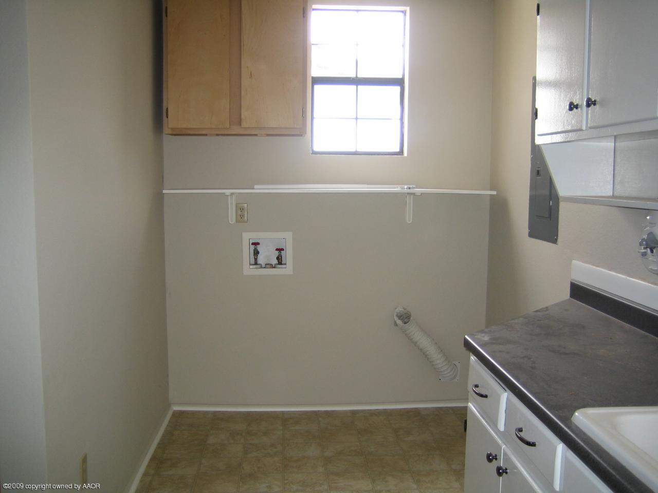5019 Bowie Street Amarillo, TX 79110 - Photo 5 of 10 an empty room with wooden floor and window
