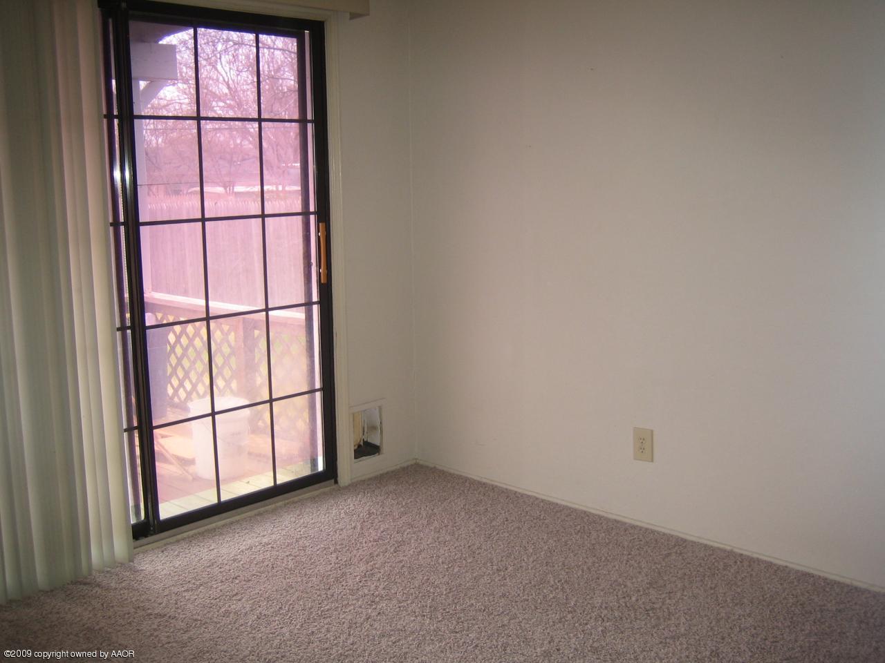 5019 Bowie Street Amarillo, TX 79110 - Photo 6 of 10 an empty room with a window