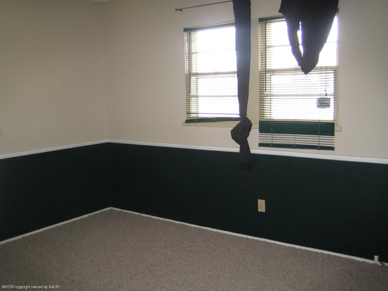 5019 Bowie Street Amarillo, TX 79110 - Photo 8 of 10 an empty room with a window