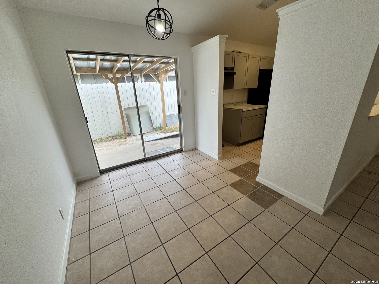12219 Ridge Crown Street San Antonio, TX 78247 - Photo 6 of 17 a view of a refrigerator and an empty room and wooden floor