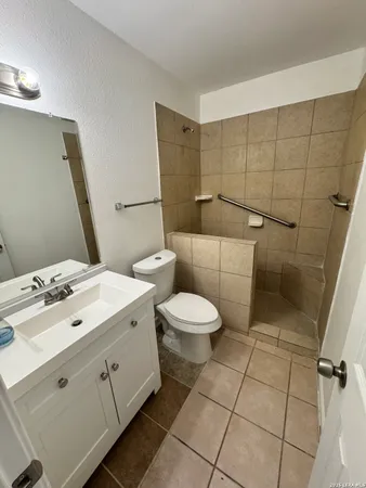 a bathroom with a toilet sink and mirror