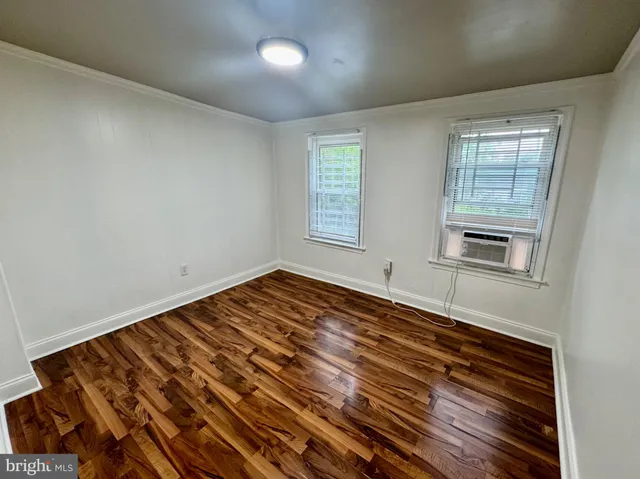 a view of a room with wooden floor and window