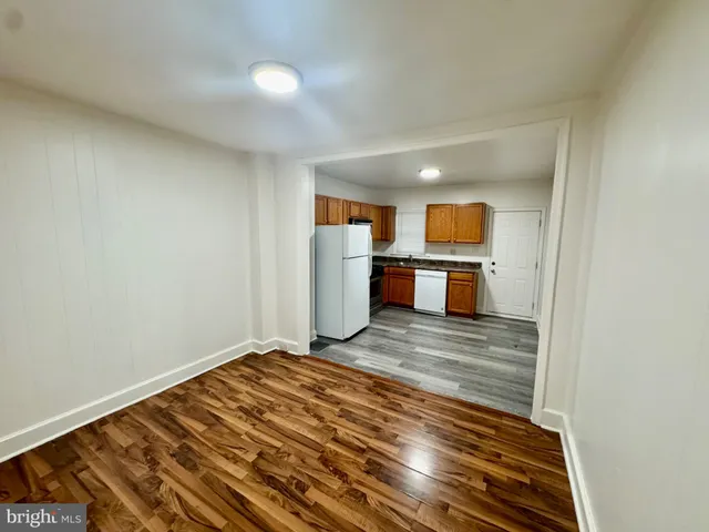 a view of a kitchen with a sink and a refrigerator