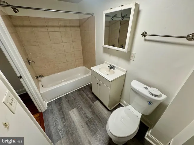 a white toilet sitting next to a bathroom sink
