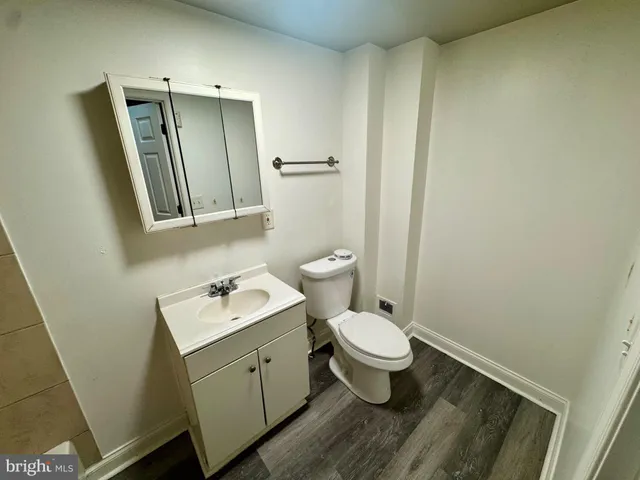 a bathroom with a sink toilet and mirror