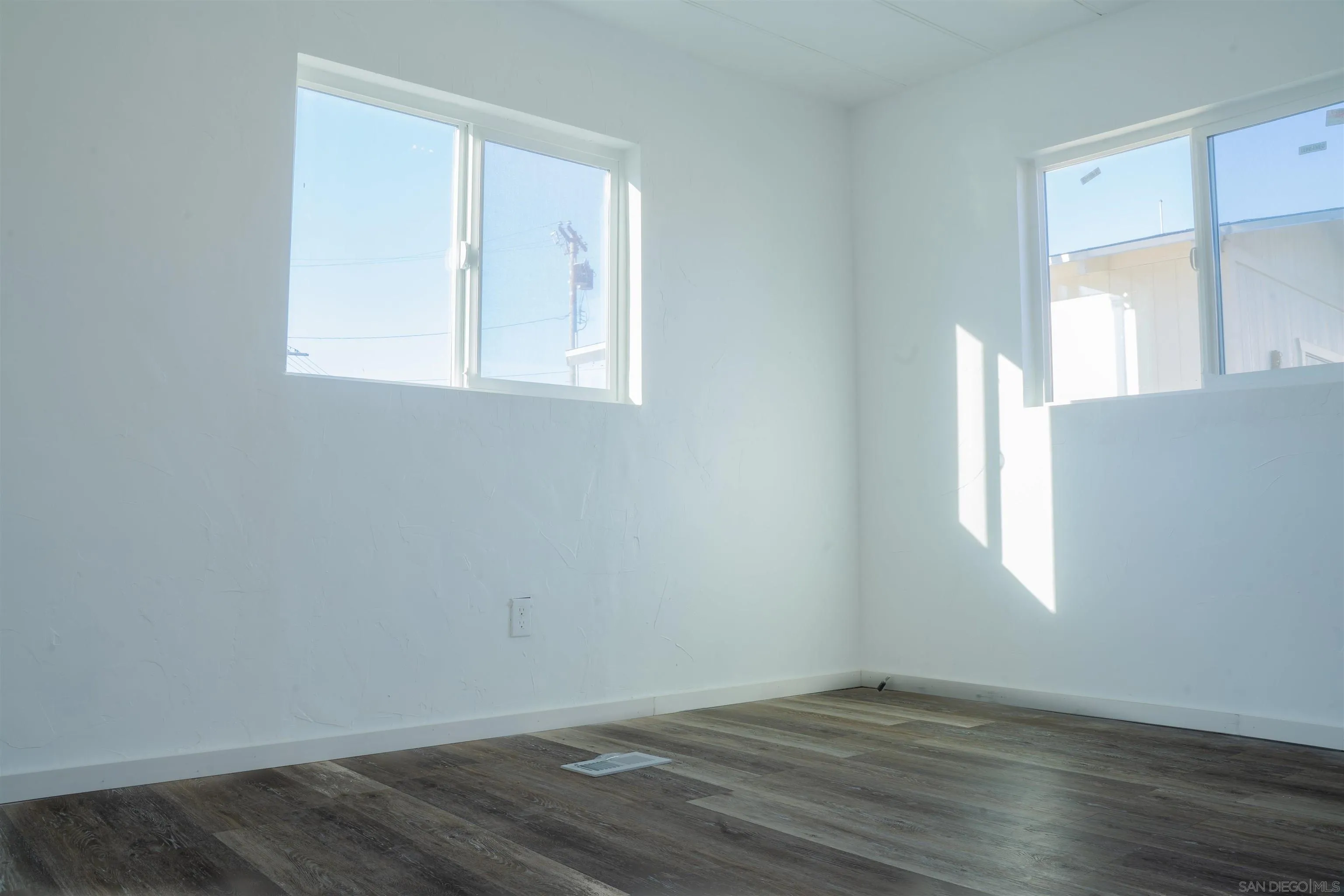 3221 Bancroft Drive, Unit SPC 1 Spring Valley, CA 91977 - Photo 14 of 22 an empty room with wooden floor and windows