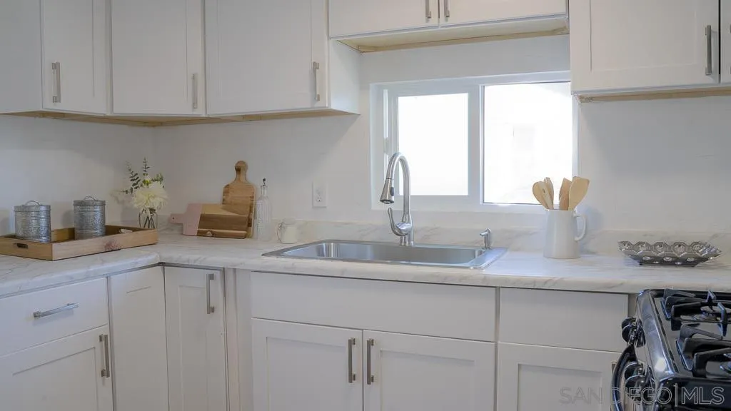 3221 Bancroft Drive, Unit SPC 1 Spring Valley, CA 91977 - Photo 4 of 22 a kitchen with white cabinets and a sink