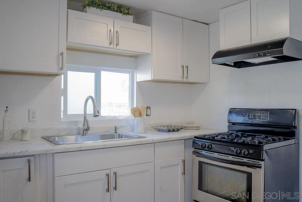 3221 Bancroft Drive, Unit SPC 1 Spring Valley, CA 91977 - Photo 5 of 22 a kitchen with stainless steel appliances granite countertop a sink stove and cabinets