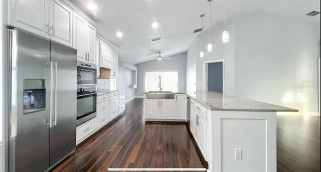 a kitchen with cabinets and stainless steel appliances