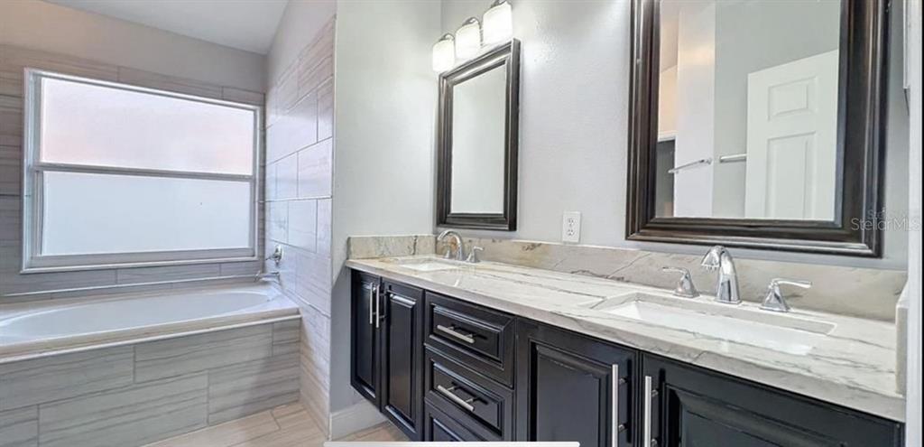 167 Haversham Way Davenport, FL 33897 - Photo 5 of 7 a bathroom with a granite countertop sink and a mirror