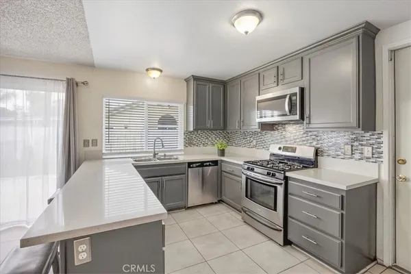 a kitchen with a stove a sink and a microwave