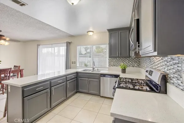 a kitchen with a sink stove and cabinets