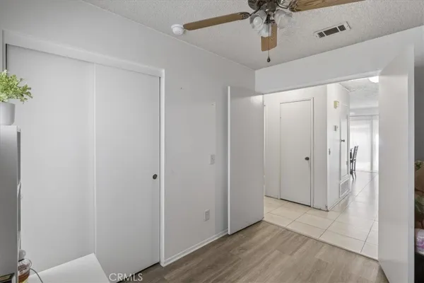 a view of a hallway with a chandelier fan